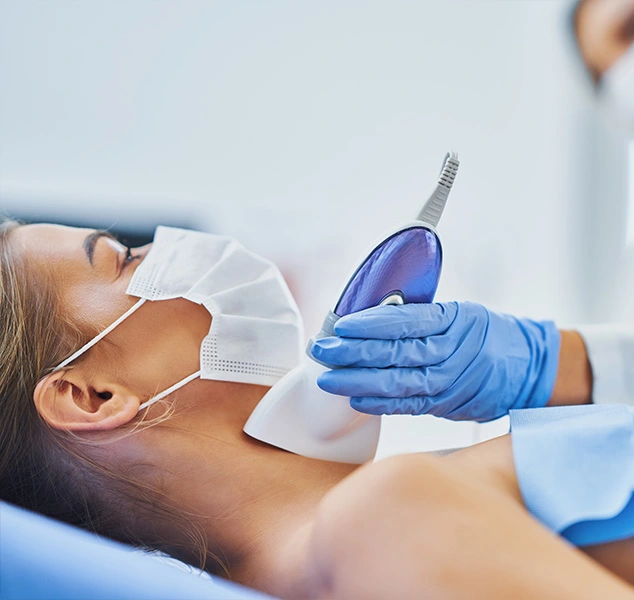 Woman receiving laser hair removal on her neck.